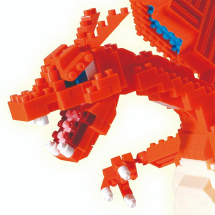 A close-up view of a red LEGO dragon-like toy, composed of numerous small LEGO bricks, with a fierce expression and sharp teeth.