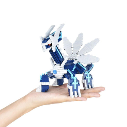 A hand holding a blue and white LEGO dinosaur-like toy.