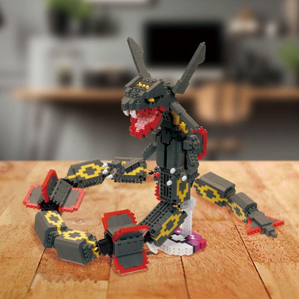 A LEGO snake toy is sitting on a wooden surface, with its head and body made up of LEGO bricks.