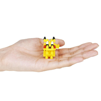 A hand holding a small yellow pixel art character, likely Pikachu, against a white background.