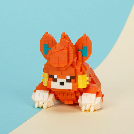A colorful, pixelated toy resembling a cat or small animal, composed of small orange and yellow blocks, is sitting on a light blue and beige background.