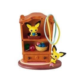 A wooden toy cabinet with two small figurines on the shelves.
