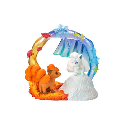 A figurine of a character from the Pokémon franchise, specifically the Pokémon franchise, is depicted in a whimsical, colorful scene. The figurine is surrounded by various elements, including a snowman, a tree, and a rainbow, creating a playful and imaginative setting.