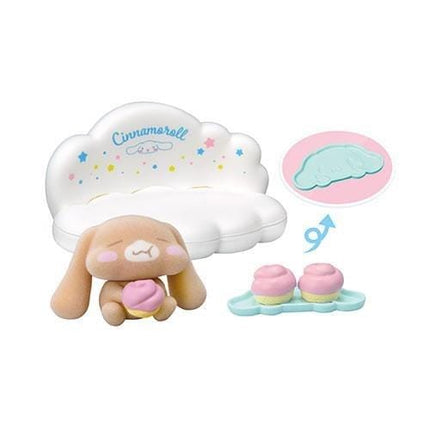 a cute stuffed animal toy, a cloud-shaped cookie cutter, and two pink cupcakes.