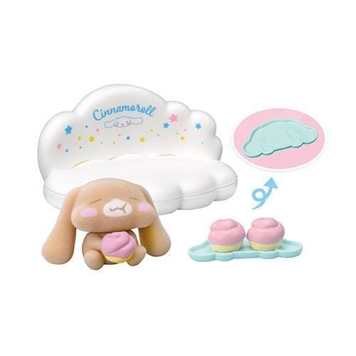 a cute stuffed animal toy, a cloud-shaped cookie cutter, and two pink cupcakes.