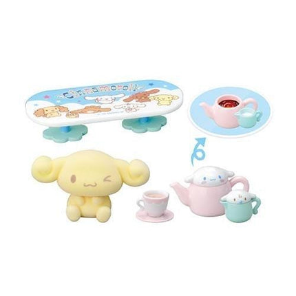 a collection of cute, cartoon-style animal figurines and a teapot, arranged in a playful and whimsical manner.