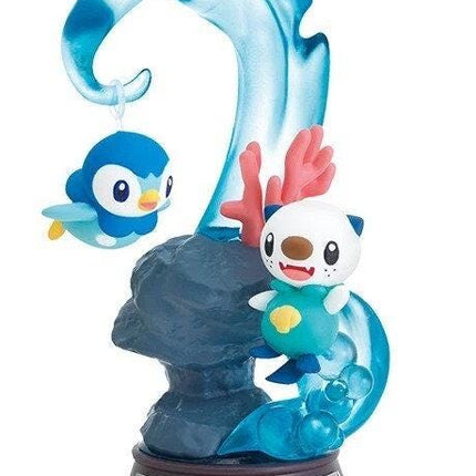 A figurine depicting two Pokemon characters, a penguin and an otter, in a whimsical underwater scene with a wave-like structure.