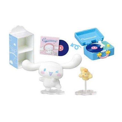 A collection of various small toys and items, including a blue record player, a white figurine, and a yellow figurine, all set against a white background.