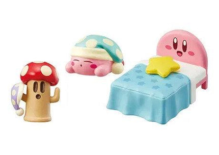 A set of three colorful toy figurines, including a mushroom, a pink character, and a bed with a yellow star, arranged together.