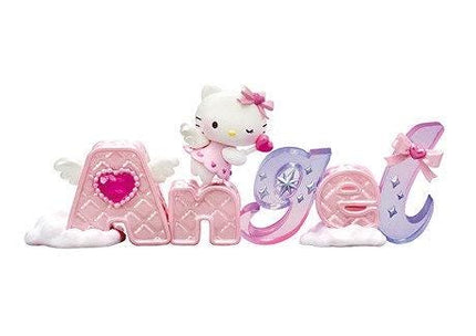 A Hello Kitty figurine is standing on top of the letters spelling out "Angel".