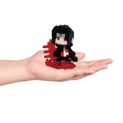 A hand holding a small, black and red figurine made of small, red and black building blocks.