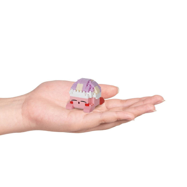 A hand holding a small, colorful toy in the palm.