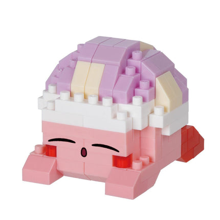 A pink and white toy figure with a smiling expression, composed of various building blocks in different colors.