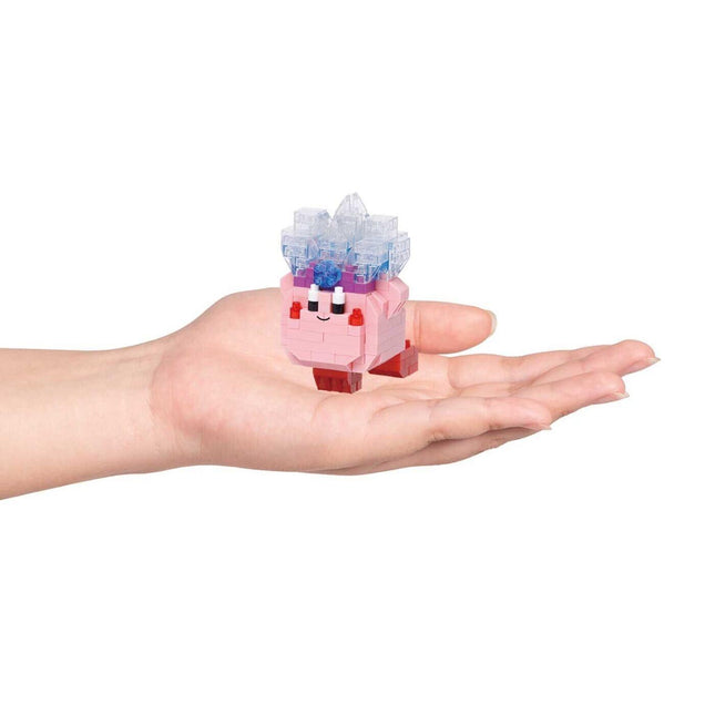 A hand holding a small pink and blue toy with a smiling face.
