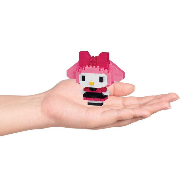 Nano building blocks character figure, pink hood and black skirt, held in hands
