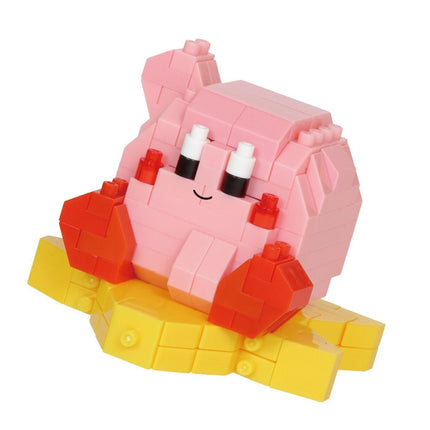 A pink and yellow toy figure made of small building blocks, with a smiling expression.