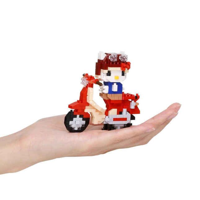 Hello Kitty Honda-style Super Cub nano block motorcycle on an open hand