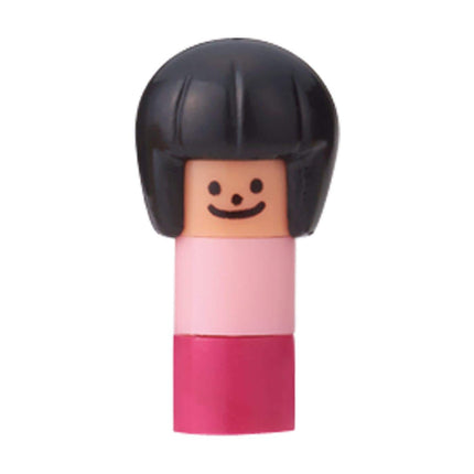 A small, colorful doll with a black hairpiece and a pink dress.