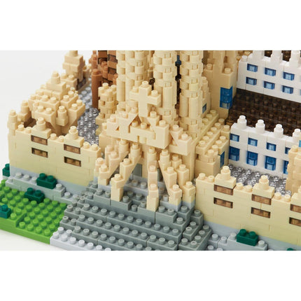 A detailed 3D model of a castle made of small, colorful building blocks.