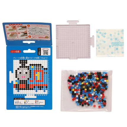 a set of items related to a craft or art project, including a blue box with instructions, a clear plastic container, and a bag filled with colorful beads.