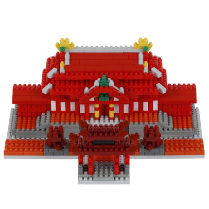A 3D model of a red and white building made of red and white building blocks, with yellow and green accents.