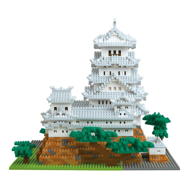 A detailed 3D model of a traditional Japanese castle, composed of numerous small white and gray blocks, set against a white background.