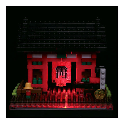 A red and black LEGO temple with a red lantern featuring Chinese characters, surrounded by various LEGO pieces and accessories, all illuminated by red lights.