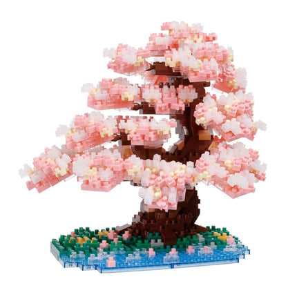A meticulously crafted miniature bonsai tree made entirely of small, colorful building blocks, creating a vibrant and detailed representation of a blossoming tree.