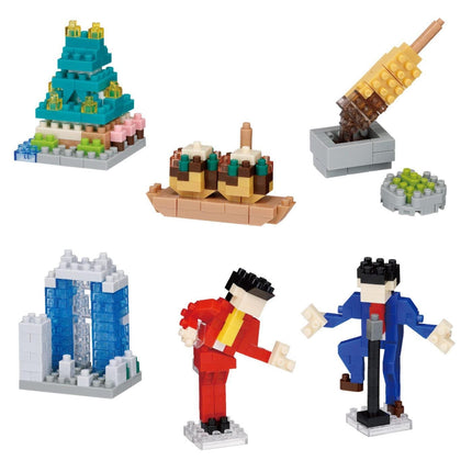 a collection of seven different objects, including a pyramid-shaped structure, a cupcake-shaped structure, a popsicle stick structure, a miniature model of a building, two figures, and a popsicle stick structure.