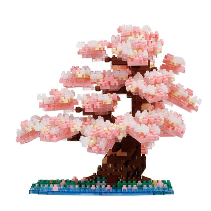 A meticulously crafted miniature bonsai tree made entirely of small, colorful building blocks, creating a vibrant and detailed representation of a blossoming tree.