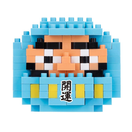 A pixelated image of a character composed of blue and orange blocks, with a small label in the center that contains Japanese text.