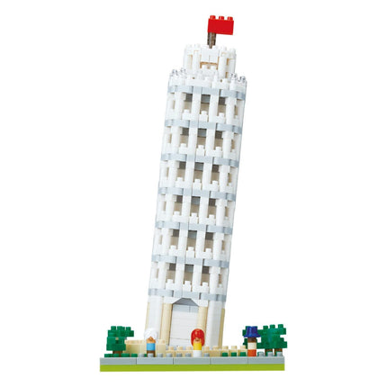 A white Lego tower with a red flag on top, surrounded by green trees and small figures.