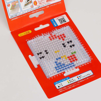 a red and white package with a clear plastic window, displaying a colorful pattern of dots and numbers.