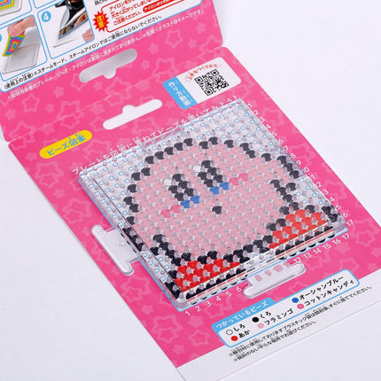 a pink and white packaging for a pixel art design kit, featuring a pixelated character design.