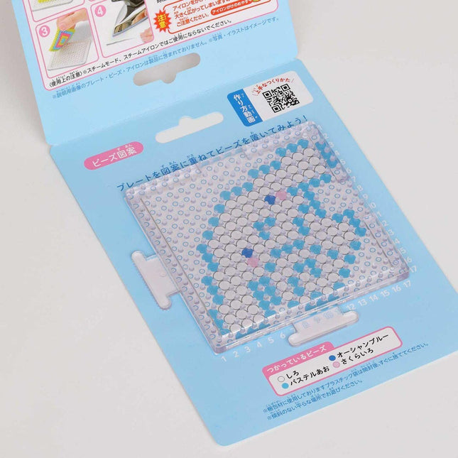 DIY perler bead set with blue and white beads on a pegboard sheet