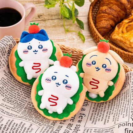 Plush bakery sandwich mascot keychain with green and white face, red pom-pom and blue cheeks