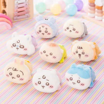 Assorted crawling plush toys with cute embroidered faces and soft pastel colors, group view