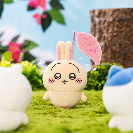 Plush bunny mascot with pink ears and dangling bead necklace, sitting