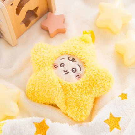 Yellow star-shaped plush with rabbit face on soft star-pattern fabric.