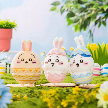 Three Easter mascot plush figures in pastel egg shells with bunny and chick faces