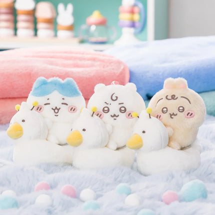 Set of plush baby potty training mascots in pastel colors, lined up on cushions