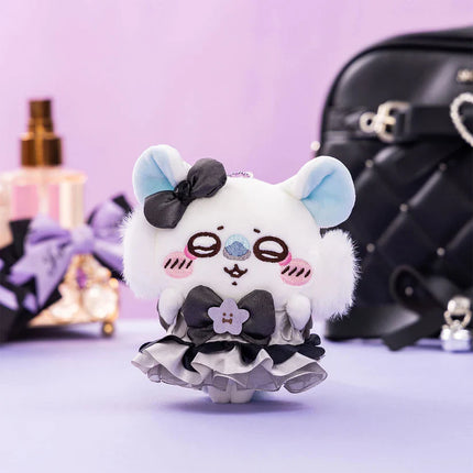White plush mascot keychain with black bow, blue ears, and ruffled skirt