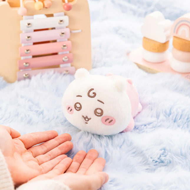 Blue-and-white crawling plush toy with smiling embroidered face and small fabric ears