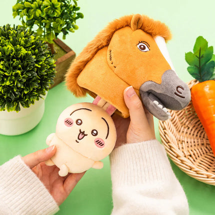 Plush horse-costume mascot and cream rabbit plush held in hands, orange mane and gray muzzle