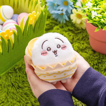 Rabbit Easter mascot plush with a yellow egg shell outfit, held in a hand