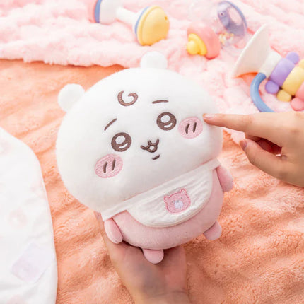 White baby swaddle plush with gray and pink character face and small pocket