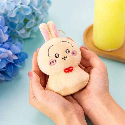 Urayahabouzu plush bunny mascot held in hands, pink ears and small red bow