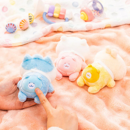 Orange, blue, pink, and yellow crawling plush toys with embroidered faces on a plush blanket