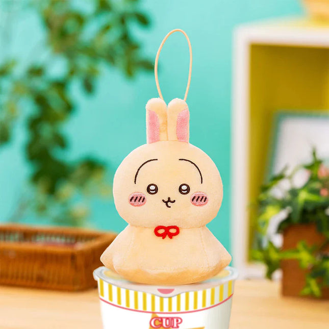 Urayahabouzu plush bunny mascot in a striped cup, pink ears and red bow