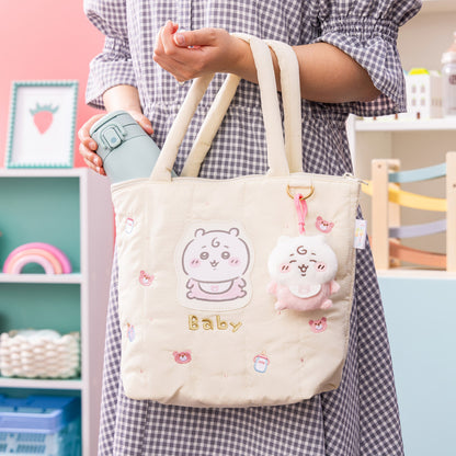 Chiikawa baby canvas tote bag with embroidered faces and a small plush charm